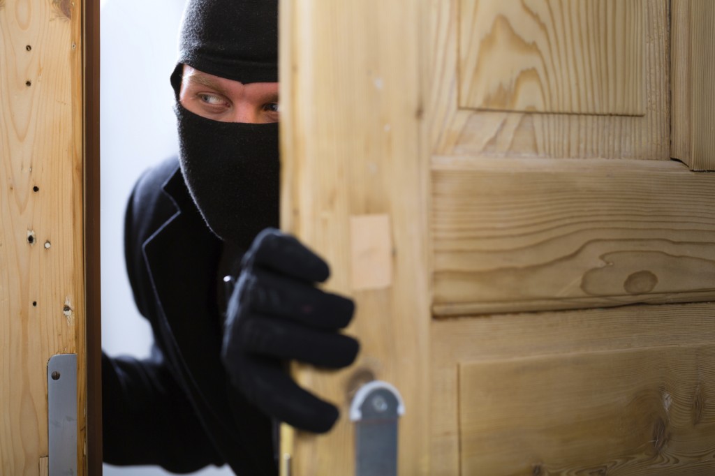 Burglary crime - burglar opening a door